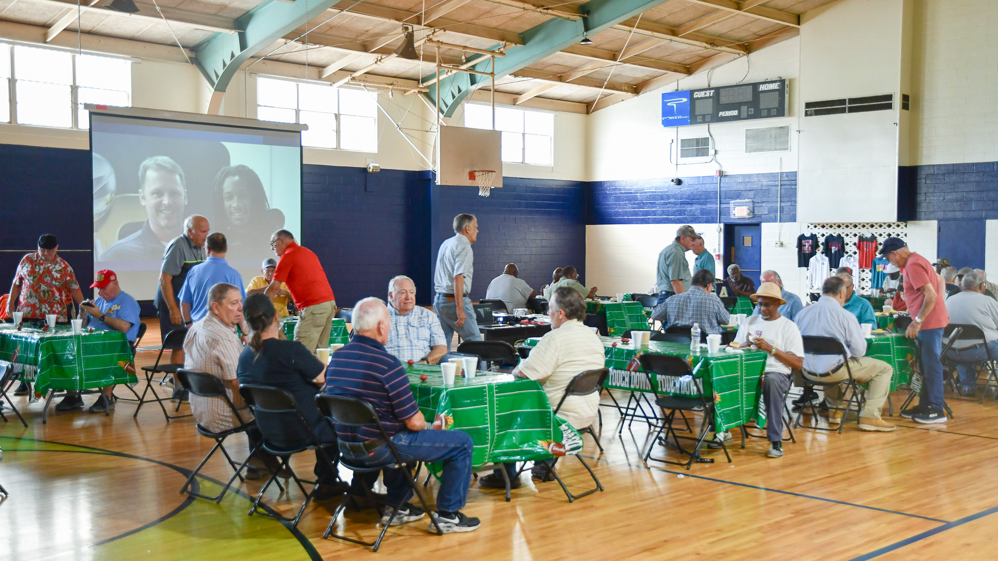Gymnasium full of event tables and people